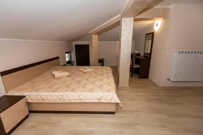 a bedroom with a large bed in a room at Hotel Kristal in Dospat