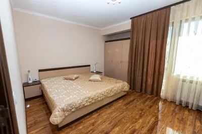 a bedroom with a bed with two pillows on it at Hotel Kristal in Dospat