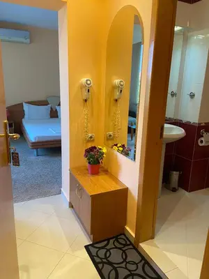 a bathroom with a sink and a mirror in a room at hotel TEDI in Asenovgrad