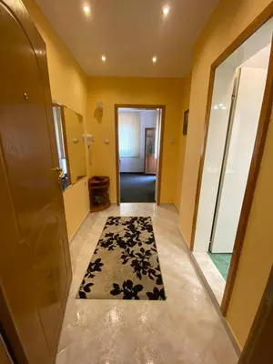 a hallway with a door and a black and white rug at hotel TEDI in Asenovgrad