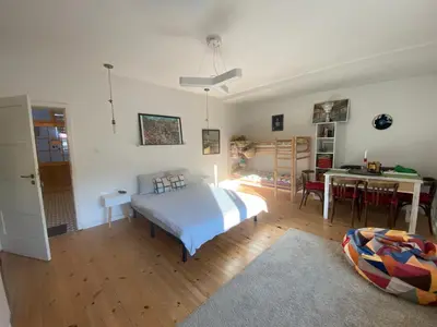 a bedroom with a bed and a dining room at The Clock house in Samokov