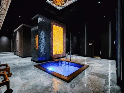 a room with a tub in the middle of a room at Premier Luxury Mountain Resort in Bansko
