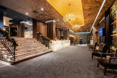 a lobby of a building with stairs and a chandelier at Premier Luxury Mountain Resort in Bansko