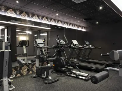 a gym with several treadmills and elliptical machines at Premier Luxury Mountain Resort in Bansko