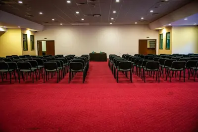 a large room with chairs and a red carpet at Zdravets SPA Hotel in Velingrad
