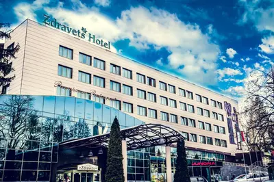 a hotel with a sign on the side of a building at Zdravets SPA Hotel in Velingrad