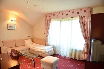 a living room with a couch and a window at Martin Club Hotel in Bansko