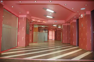 an empty hallway in a building with red walls at Hotel Leipzig in Plovdiv