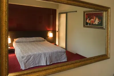 a mirror in a room with a bed in it at Famous House in Plovdiv
