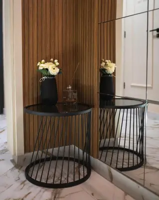 two black round tables with flowers on them at Hotel BLVD 7 in Plovdiv