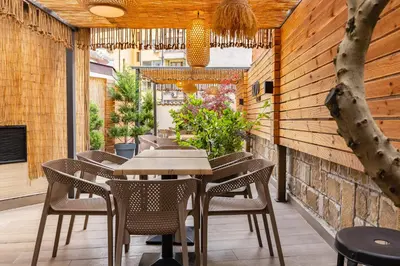 a dining area with tables and chairs on a patio at Hotel BLVD 7 in Plovdiv