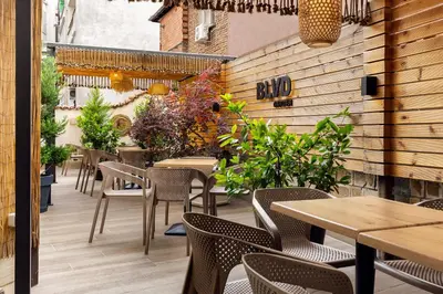 an outdoor patio with tables and chairs and plants at Hotel BLVD 7 in Plovdiv