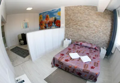 a bedroom with a bed and a brick wall at COLORED HOUSE Apartments in Sofia