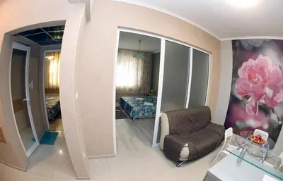 a living room with a chair and a bedroom at COLORED HOUSE Apartments in Sofia