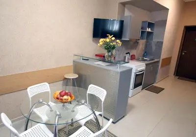 a kitchen with a table with a bowl of fruit on it at COLORED HOUSE Apartments in Sofia