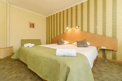 a hotel room with two beds with towels on them at Noviz Hotel in Plovdiv