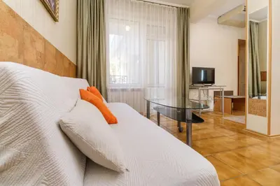 a living room with a white couch and a table at Noviz Hotel in Plovdiv