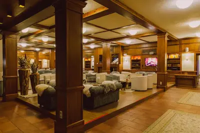 a living room with couches and tables in a room at Green Life Bansko in Bansko