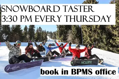 a group of people sitting in the snow on snowboards at PM Services Flora Apartments in Borovets