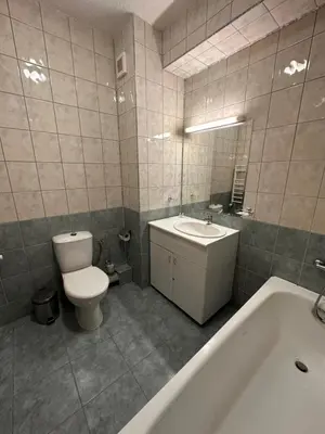 a bathroom with a toilet and a sink and a tub at PM Services Flora Apartments in Borovets