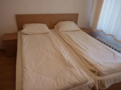 a bed with two pillows on it in a bedroom at PM Services Semiramida Apartments in Borovets