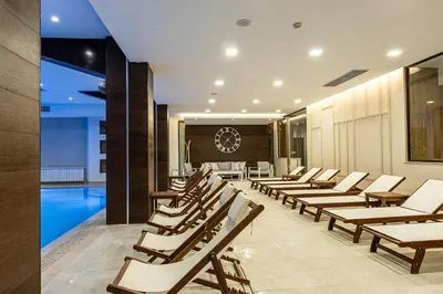 a row of lounge chairs sitting next to a swimming pool at Spa Hotel Persenk in Devin