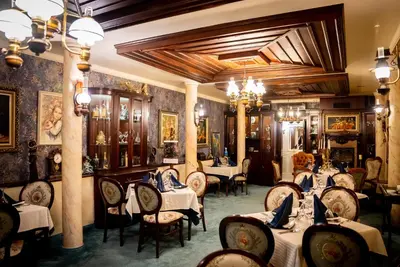 a restaurant with tables and chairs in a room at Globus Hotel in Plovdiv
