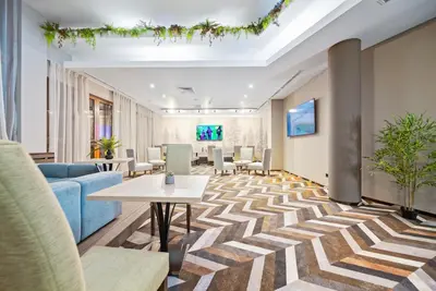 an office lobby with a table and chairs at Hotel Orlovetz in Pamporovo