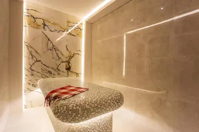a bathroom with a chair and a shower at Hotel Orlovetz in Pamporovo