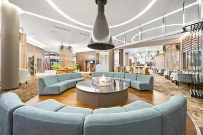 a lobby with blue couches and a coffee table at Hotel Orlovetz in Pamporovo