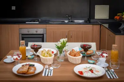 a table with plates of food and glasses of wine at Snezhanka Hotel Pamporovo - Half Board & Swimming pool in Pamporovo