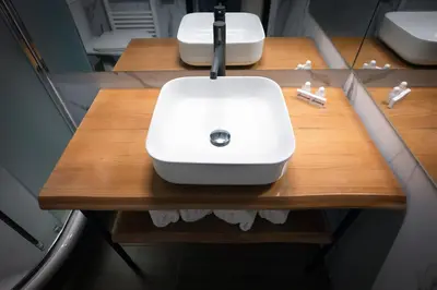 a white sink on a wooden counter in a bathroom at Snezhanka Hotel Pamporovo - Half Board & Swimming pool in Pamporovo