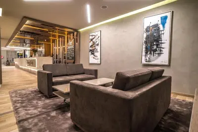 a lobby with two couches and a table at Perelik Hotel in Pamporovo