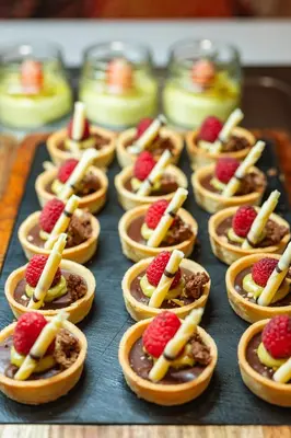 a tray filled with small pastries with fruit on them at Four Points by Sheraton Bansko in Bansko