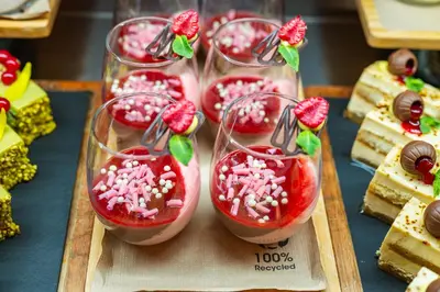 a group of four desserts in glasses on a tray at Four Points by Sheraton Bansko in Bansko