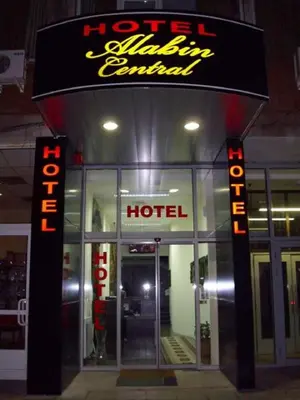 a hotel with a sign on the front of it at Hotel Alabin Central in Sofia
