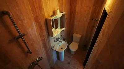 a small bathroom with a sink and a toilet at Hotel Alabin Central in Sofia