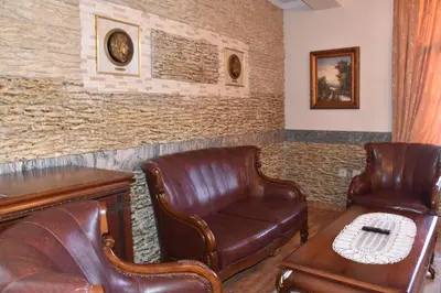 a waiting room with two leather chairs and a table at Boutique Hotel Boris Palace & Restaurant in Plovdiv