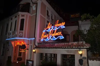 a neon sign on the side of a building at Boutique Hotel Boris Palace & Restaurant in Plovdiv