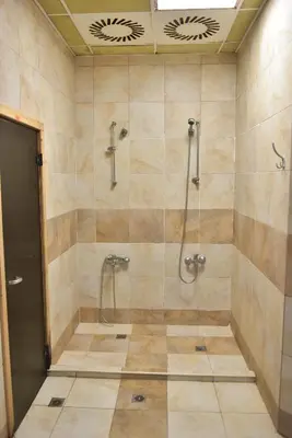 a bathroom with a shower with a glass door at Royal Bansko Family Apart Hotel - All Inclusive Light or Half Board & Drinks With Heated Indoor Pool & Jacuzzis in Bansko