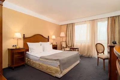 a hotel room with a bed and two windows at Festa Winter Palace Hotel in Borovets