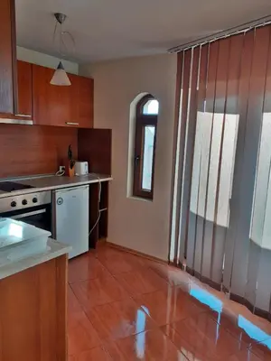 a kitchen with a stove and a counter top at Pirin Place Bansko in Bansko