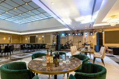 a hotel lobby with tables and chairs and a bar at Astoria Grand Hotel in Sofia