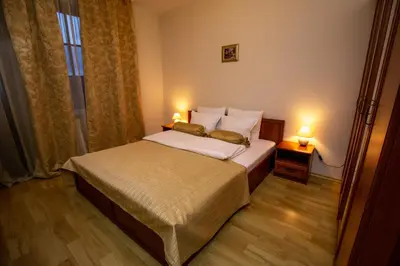 a hotel room with a bed and two lamps at Pinerose Resort in Bansko