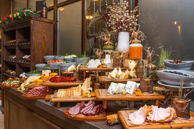 a buffet filled with different types of meats and cheese at MPM Hotel Sport Ski-in, Ski-out in Bansko