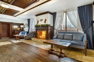 a living room with a couch and a fireplace at MPM Hotel Sport Ski-in, Ski-out in Bansko
