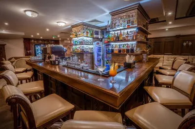 a bar in a restaurant with a lot of chairs at MPM Hotel Sport Ski-in, Ski-out in Bansko