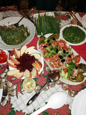 a table topped with plates of food and bowls of salad at Family Hotel Santo Bansko in Bansko
