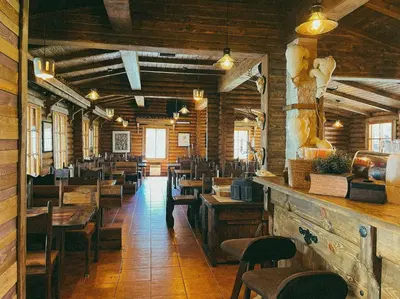 a dining room with wooden tables and chairs at Villas Jagoda & Malina in Borovets