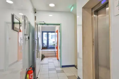 a hallway of a building with a fire extinguisher at easyHotel Sofia in Sofia